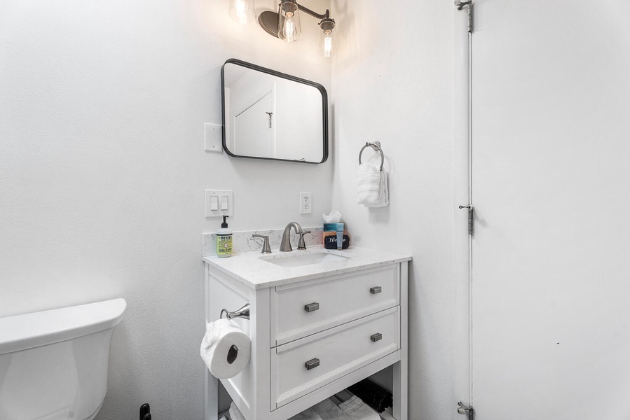Guest bathroom with modern vanity and thoughtful touches for a stress-free stay.
