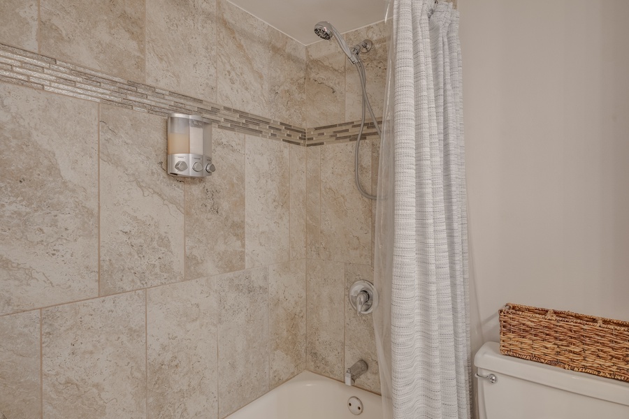 The shared bathroom shower/tub combo.