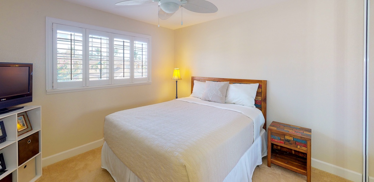 The cozy second guest bedroom with scenery.