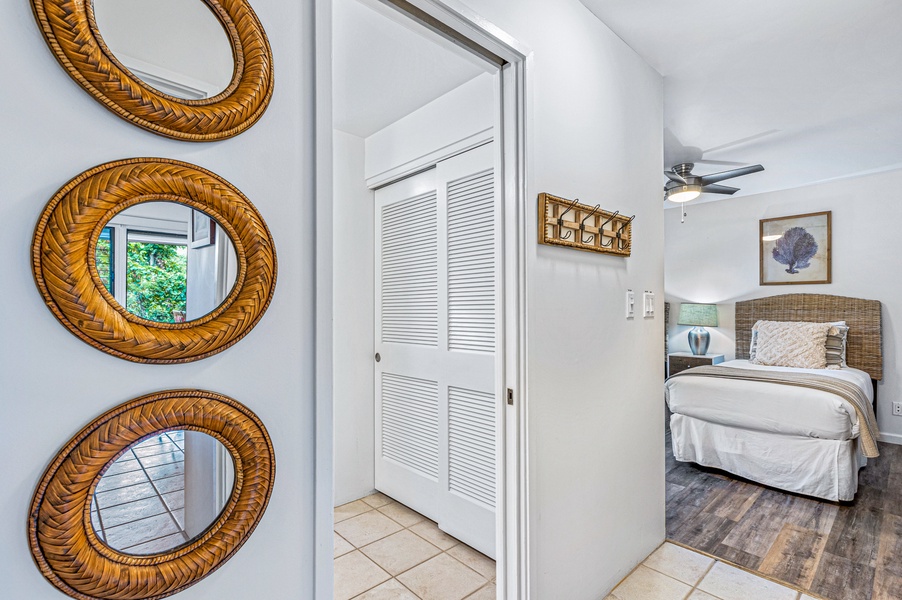 A bright hallway leads to the serene bedroom, adding a touch of elegance with decorative accents.