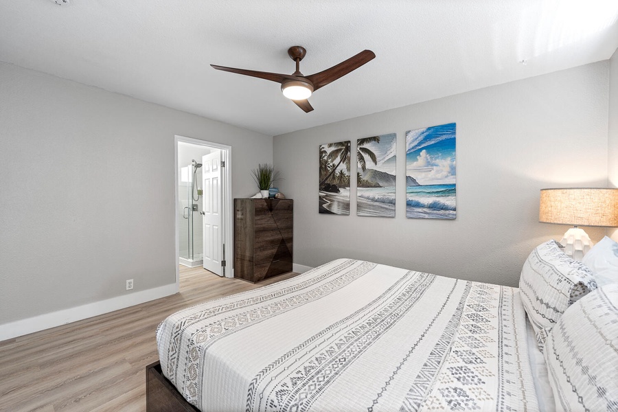Downstairs Junior primary featuring king bed, ceiling fan, and tropical touches.