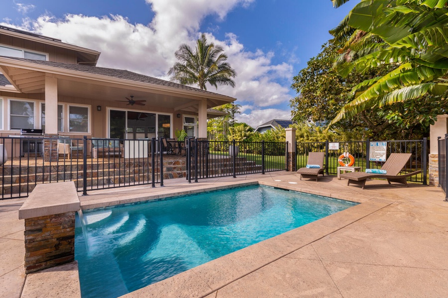 Gated pool area at Pohaku Villa with ample patio space, ideal for safe and relaxing family fun.