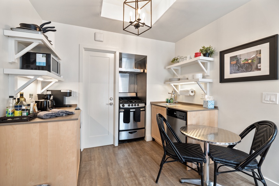 The kitchen area delights with a full gas range, oven, dishwasher, coffee maker, and space appropriate fridge and freezer