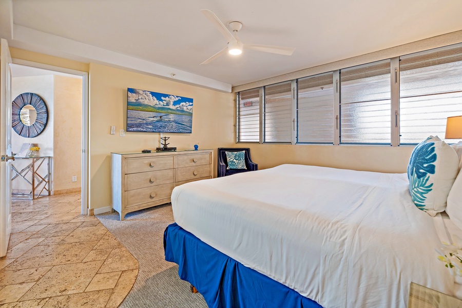 The guest bedroom at Royal Kahana 610 offers a spacious layout with a comfortable king-sized bed and a relaxing atmosphere.