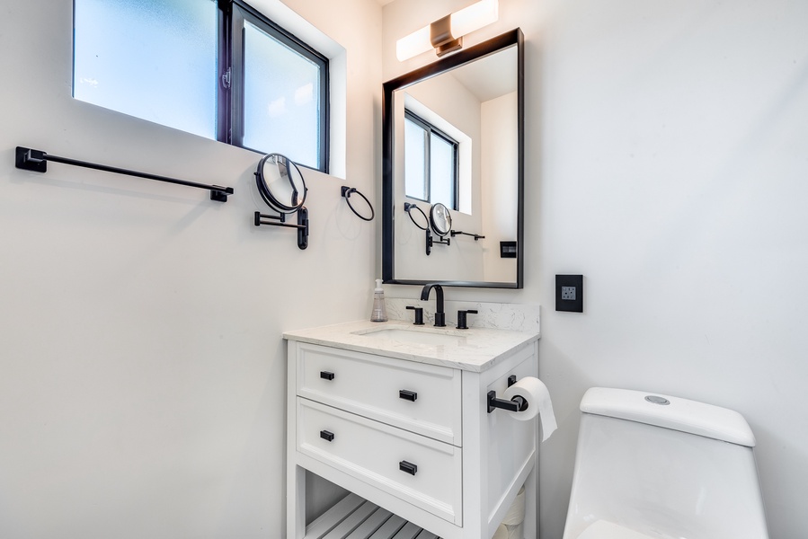 Clean, white-finish bathroom with a walk-in shower.