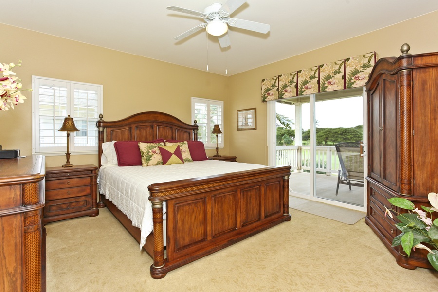 The primary guest bedroom with grand furnishings and access to the upper lanai.