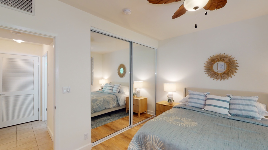 Large mirrors and a ceiling fan in the second guest bedroom.