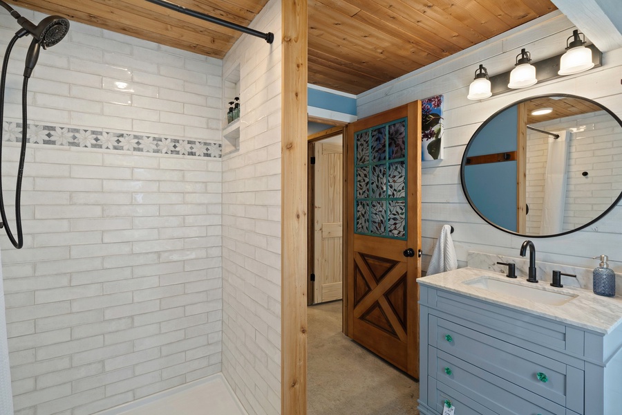 The spacious walk-in shower offers a refreshing start or relaxing end to your day in nature.