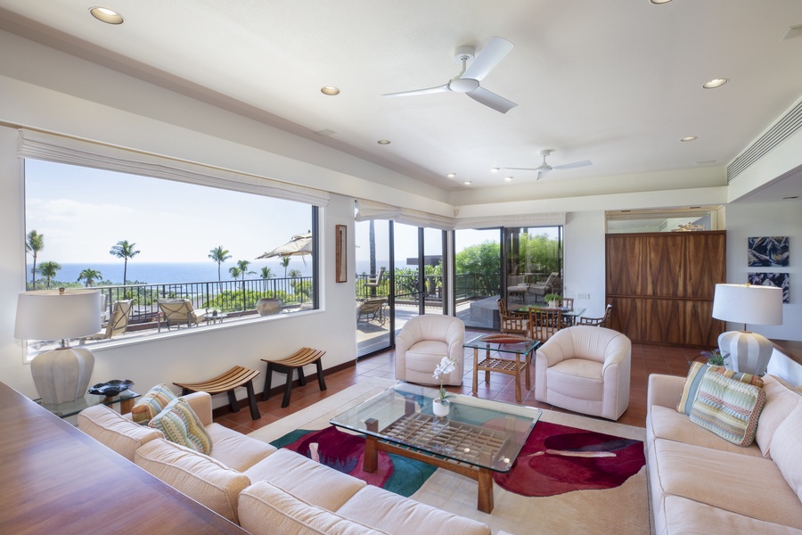 Relax in the airy living room with breathtaking ocean vistas and open access to the outdoor lanai.