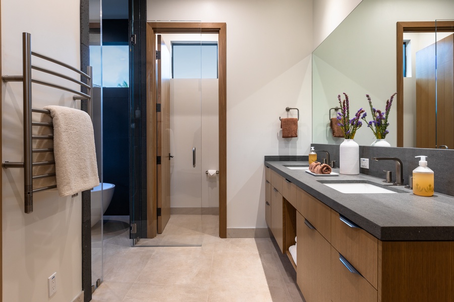 The bathroom has dual vanity spaces.