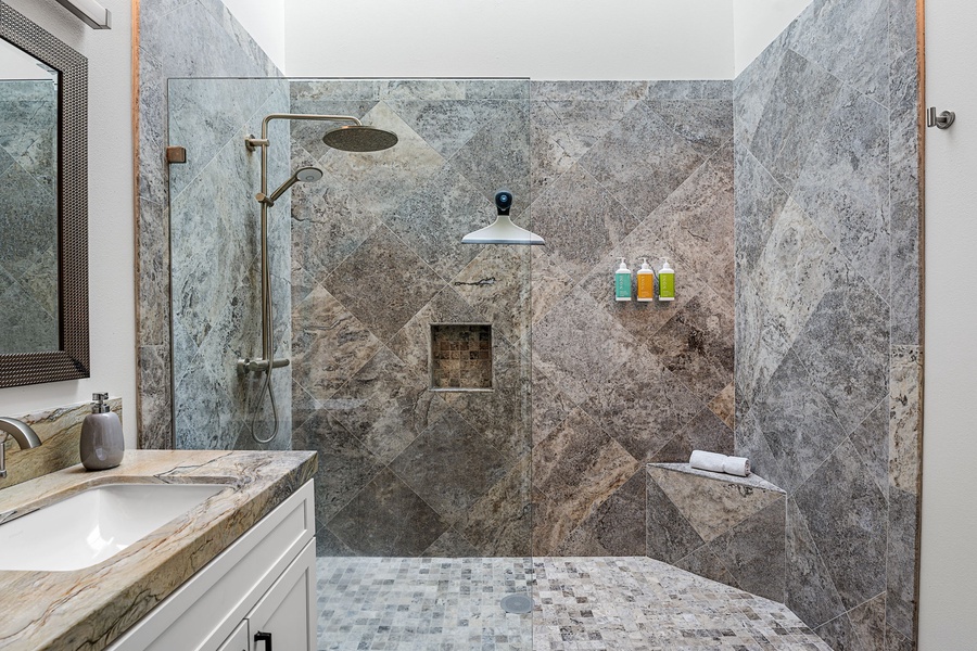 Relax in a spa-like shower, complete with stone finishes and a built-in bench.