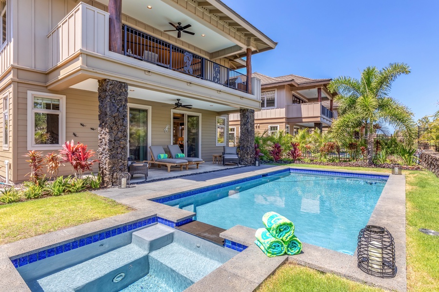 Private pool, jacuzzi and tropically landscaped garden appoint the backyard of this elegant split-level home.