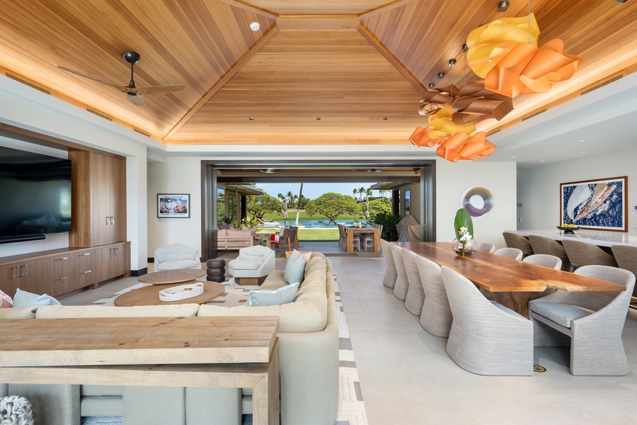 Unwind in your beautiful open-concept living space where floor-to-ceiling pocket doors frame tropical views.
