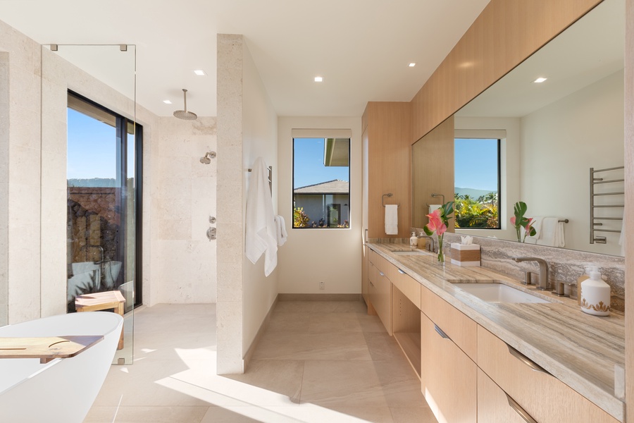 Unwind in your spa-like bathroom with soaking tub, rainfall shower, and stunning views through floor-to-ceiling windows.