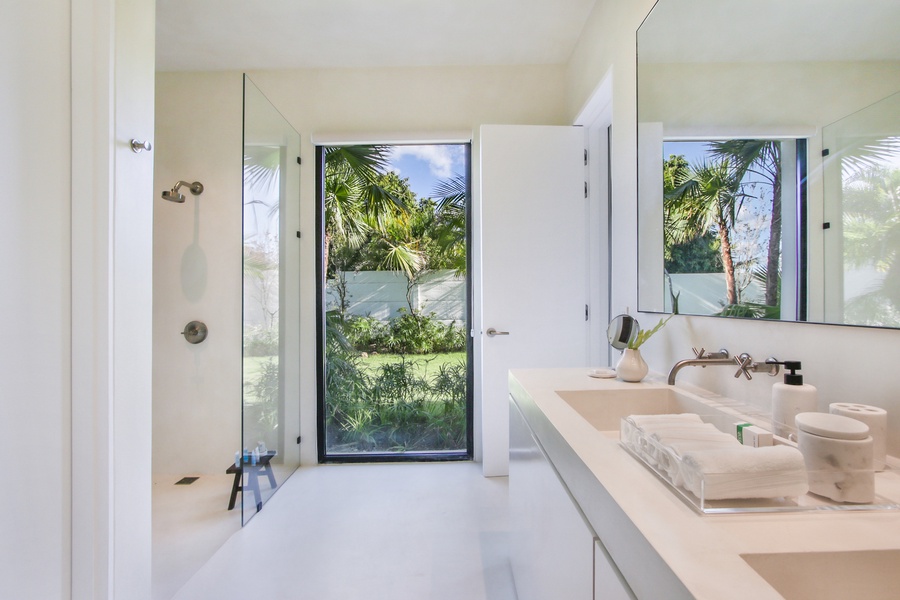 Refresh in the ensuite full bathroom with a garden view.