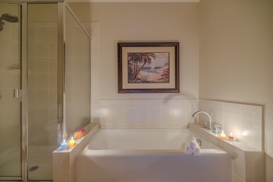 Unwind in a luxurious bathroom with a soaking tub and candles for added relaxation.