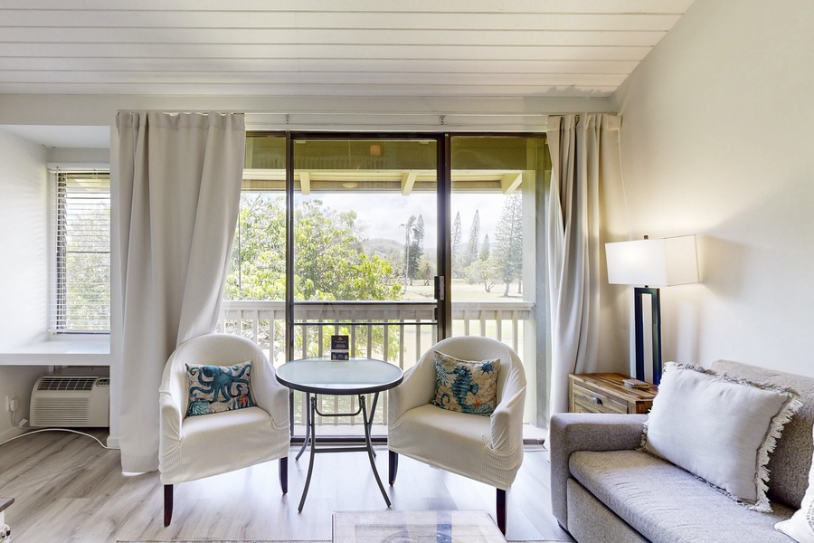 Sunny sitting nook with peaceful golf-course backdrop.