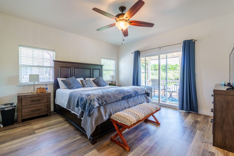 The primary guest bedroom is located upstairs with ceiling fan and natural lighting.