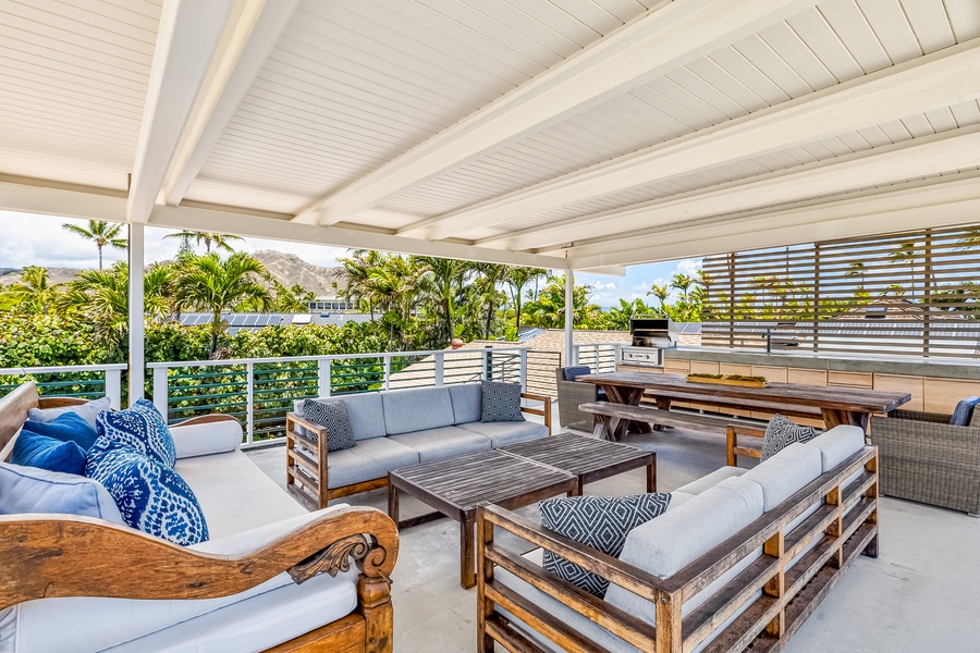 Rooftop deck with built-in BBQ, lounge, and dining spaces with peekaboo ocean views