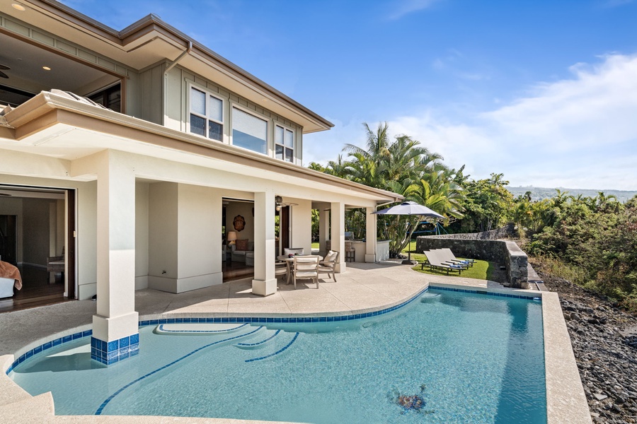 Poolside patio offering shaded dining and lounging options for guests.