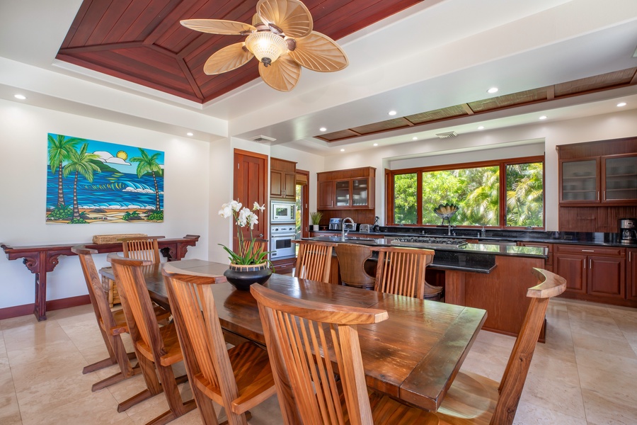 Spacious dining area with a large wooden table and chairs, adjacent to a modern kitchen, perfect for family meals and gatherings.