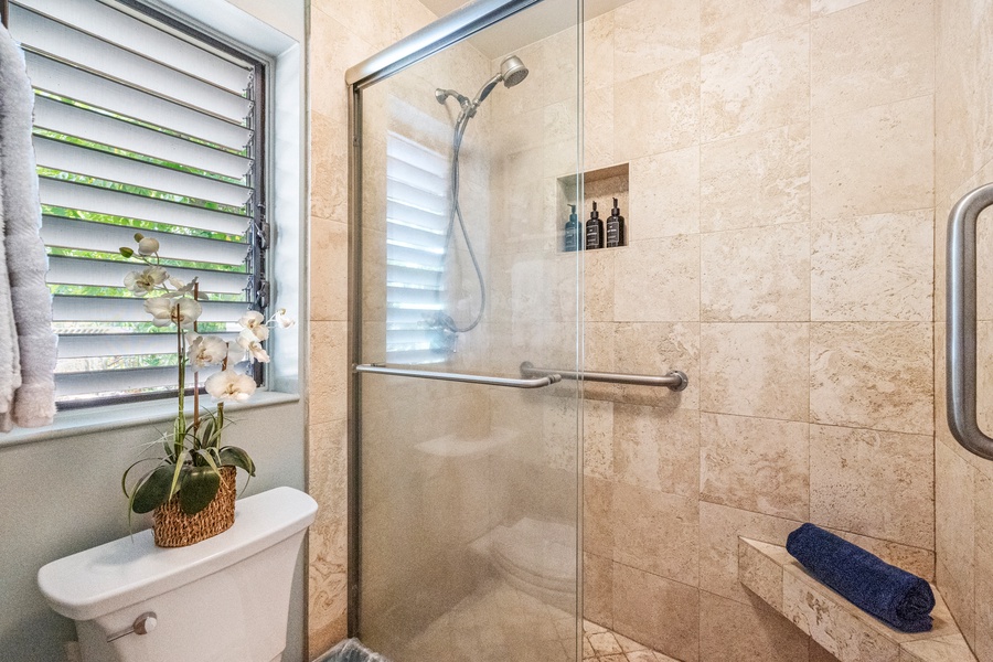 Modern tiled shower at Wailea Ekolu 1106 with built-in nook and handheld showerhead.