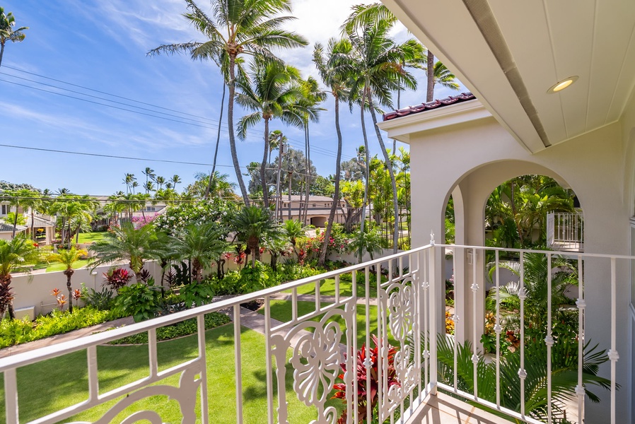 Private lanai with views of lush gardens and palm trees, offering a perfect spot to enjoy the tropical scenery.