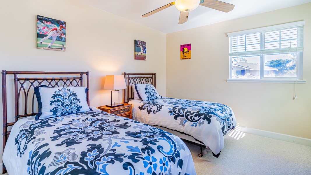 The inviting second guest bedroom with twin beds and luxurious comforters.