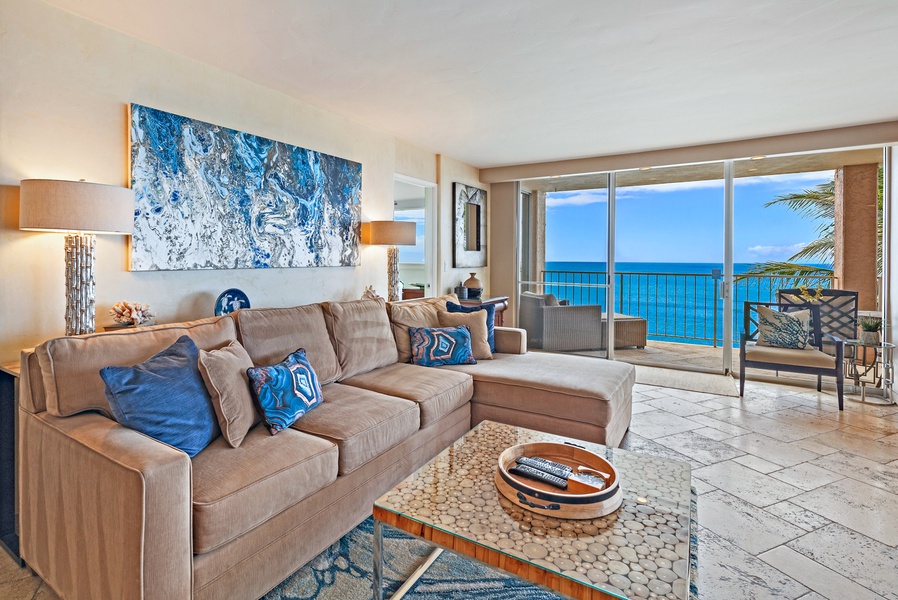 Royal Kahana 610's living room offers comfortable seating with direct access to the lanai and beautiful ocean views.