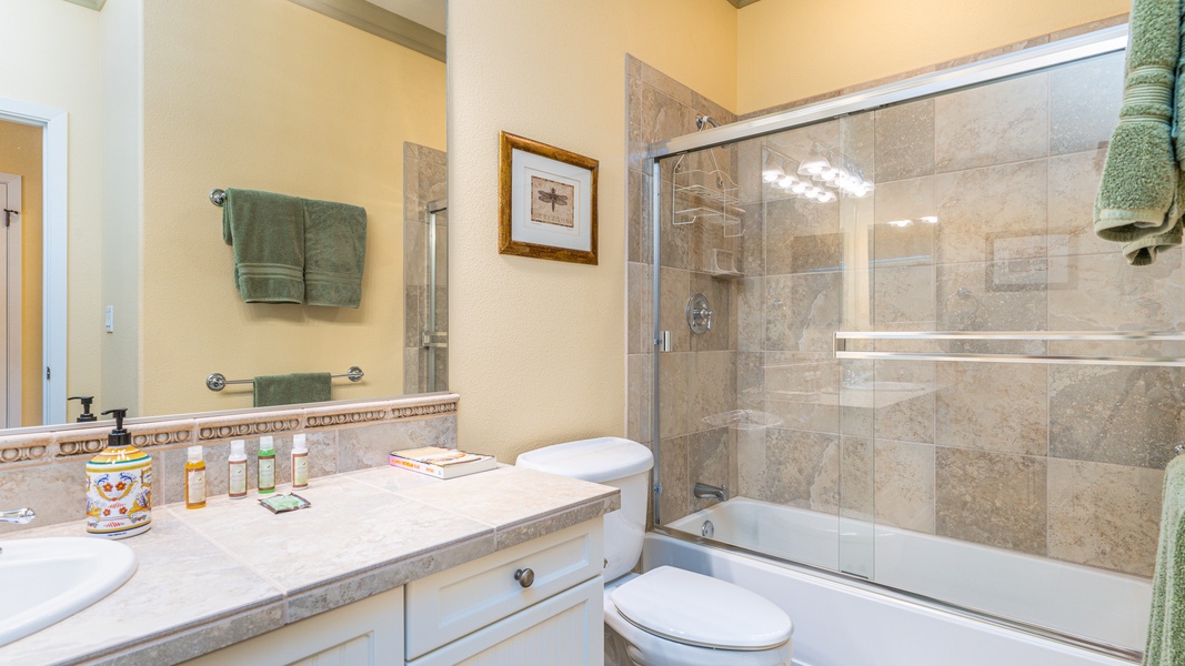 The downstairs guest bathroom with a shower and tub combo.