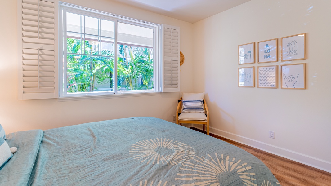 The second guest bedroom has a queen bed, scenery and tasteful decor.