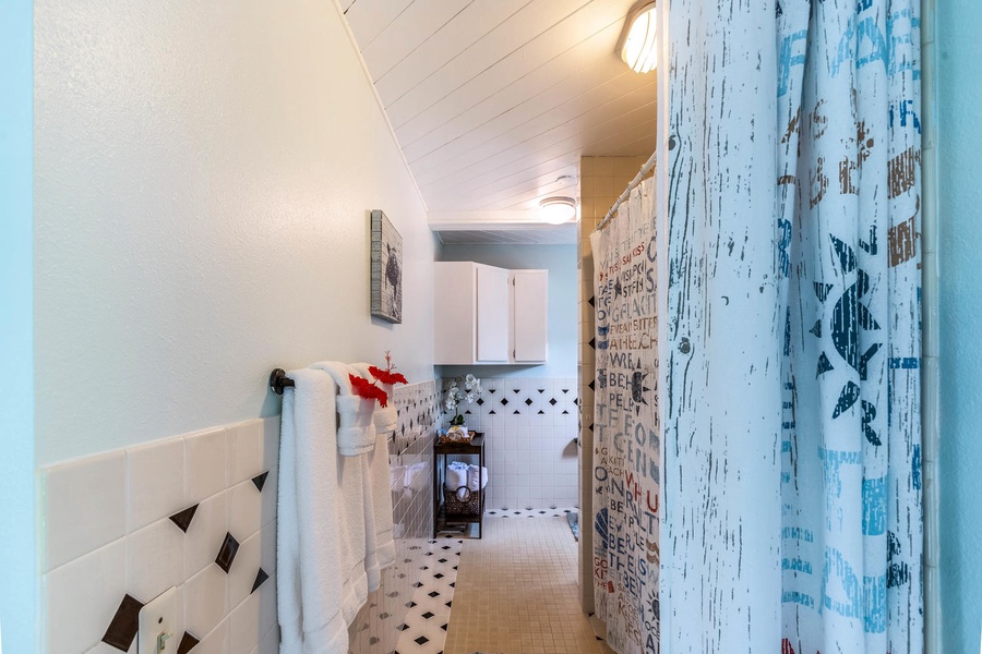 Bright and airy hallway leading to the bathroom, featuring coastal-inspired accents and thoughtful touches.