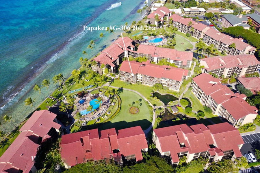 This aerial view shows the resort's layout, with direct access to the ocean and beautifully maintained tropical grounds, including the pool area.