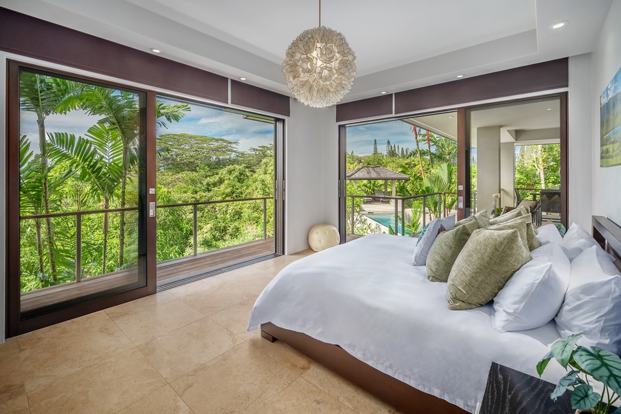 "Hanalei Bedroom" with large windows and views of the pool, creating a relaxing and inviting space.