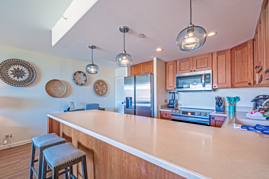 The kitchen island offers plenty of counter space and seating, making it a great spot for quick meals or socializing while cooking.