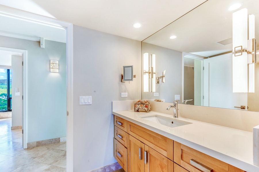 The large ensuite bathroom features a single vanity area.