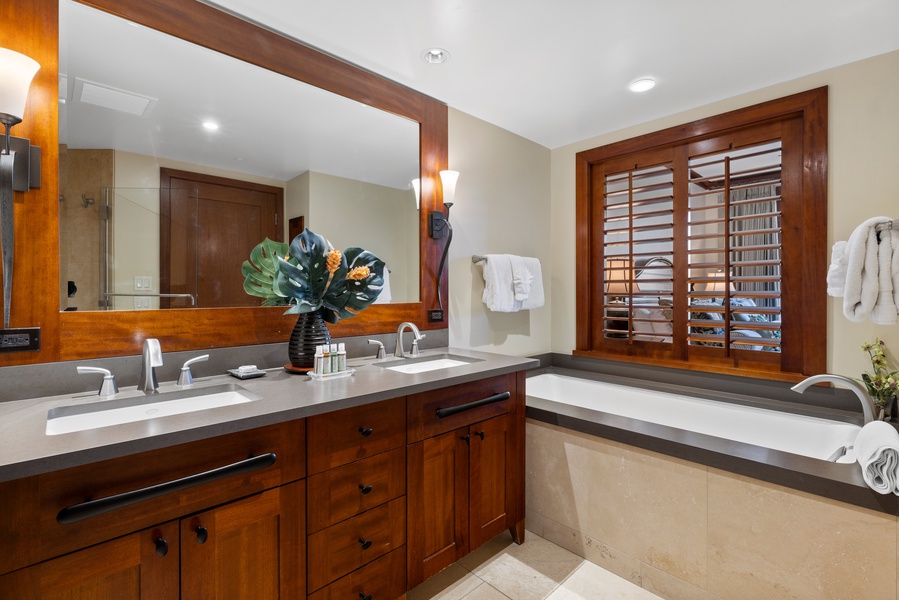 The primary guest bathroom features a soaking tub and walk-in shower.