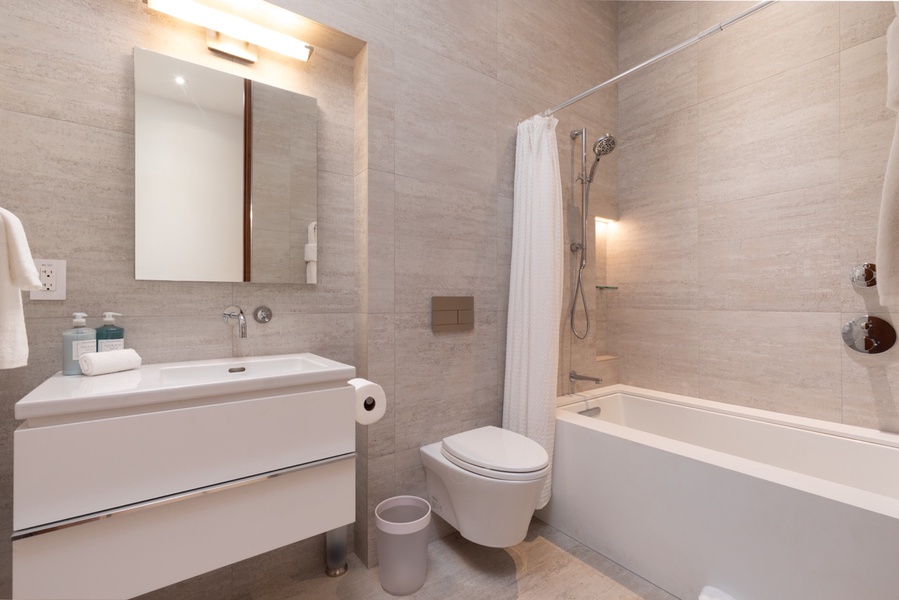 Guest Full Bathroom has modern amenities to create a refreshing, spa-like atmosphere.