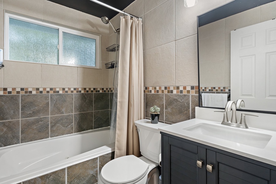 Ensuite bathroom with a bath tub.