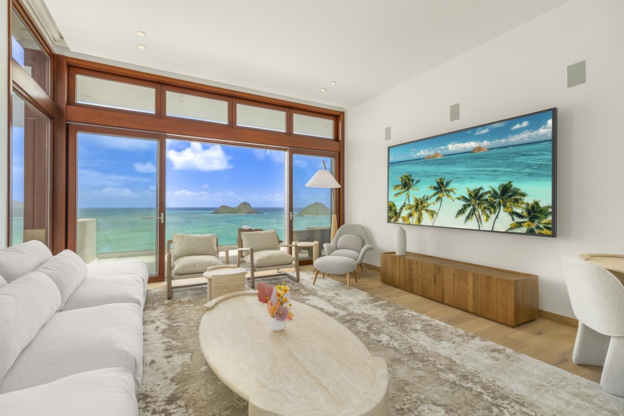 Upstairs TV room with cozy seating and breathtaking ocean views for relaxing movie nights.