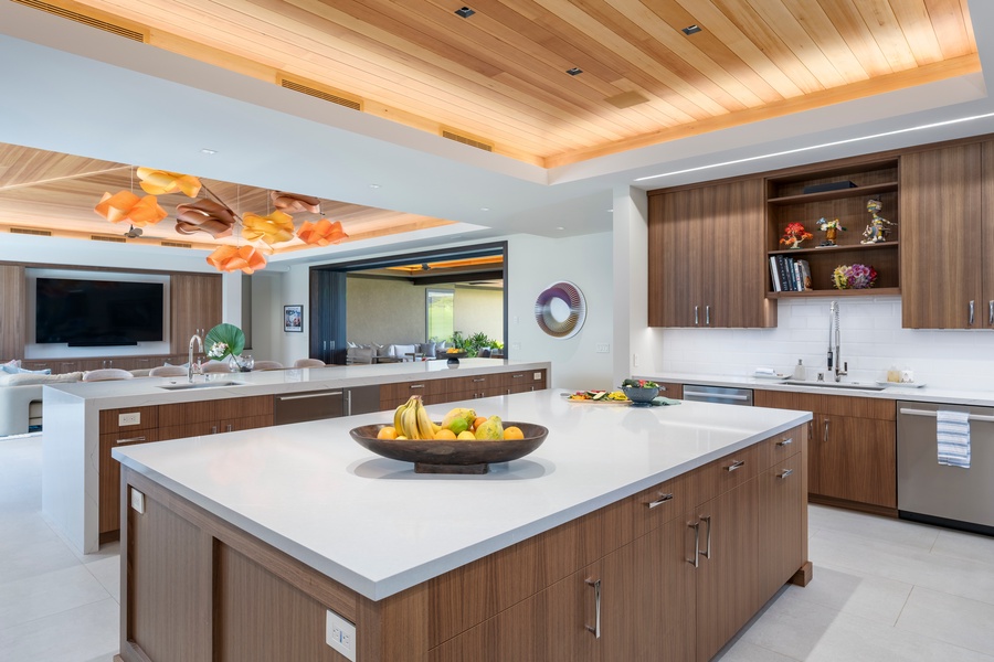 This stunning open kitchen invites you to create culinary masterpieces with premium appliances and elegant wood finishes.