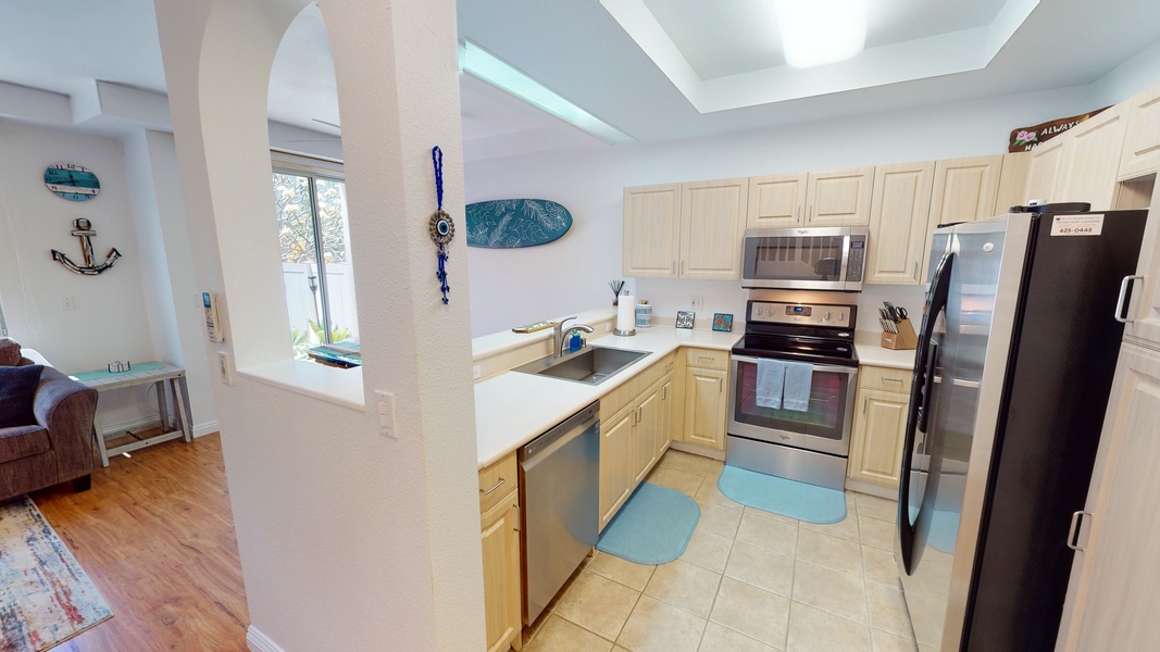 The kitchen has plentiful counter space and stainless steel appliances.