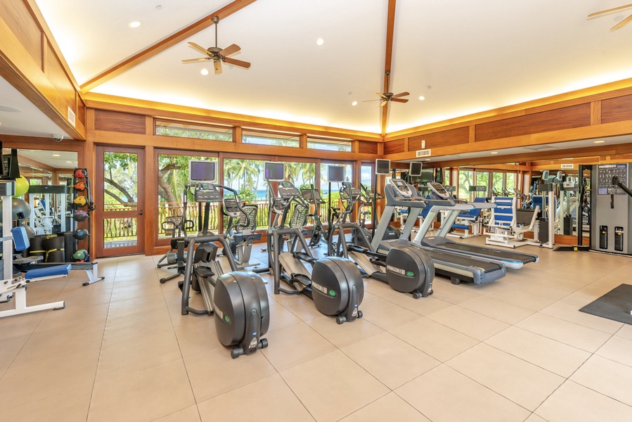 Stay fit with ocean scenery in the fully equipped fitness room of Pauoa Beach Club Amenities Center