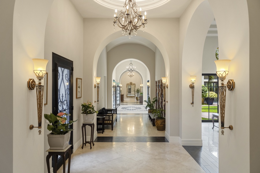 Spacious, light-filled hallway with elegant decor and striking architectural details.