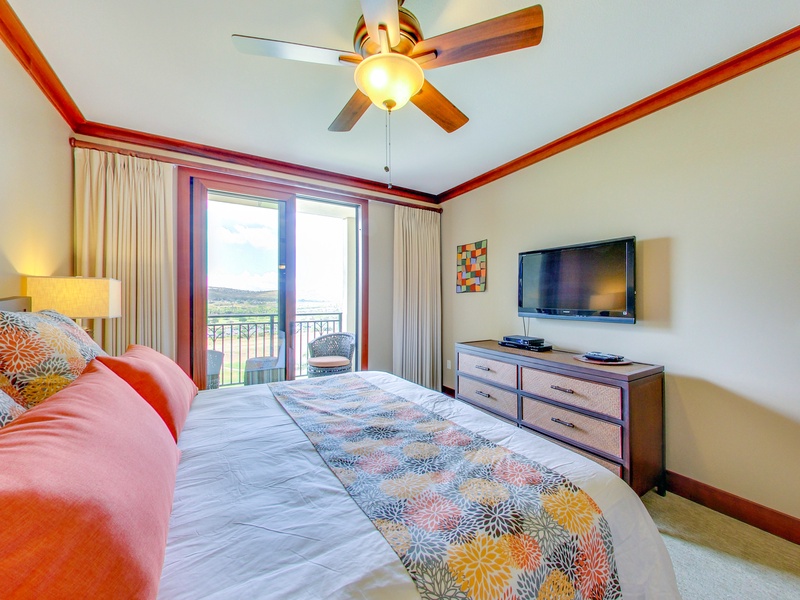 Welcome to your bright and cheery primary guest bedroom with custom bedding and a TV.