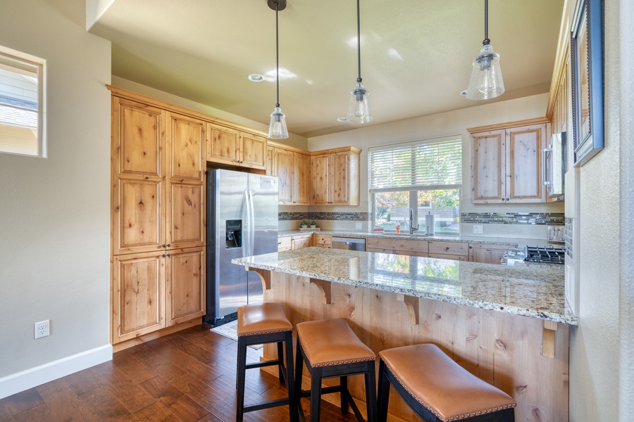 Pull up a chair to the kitchen's stylish counter bar, a convenient spot for quick meals, socializing, or sharing a drink while meals are prepared