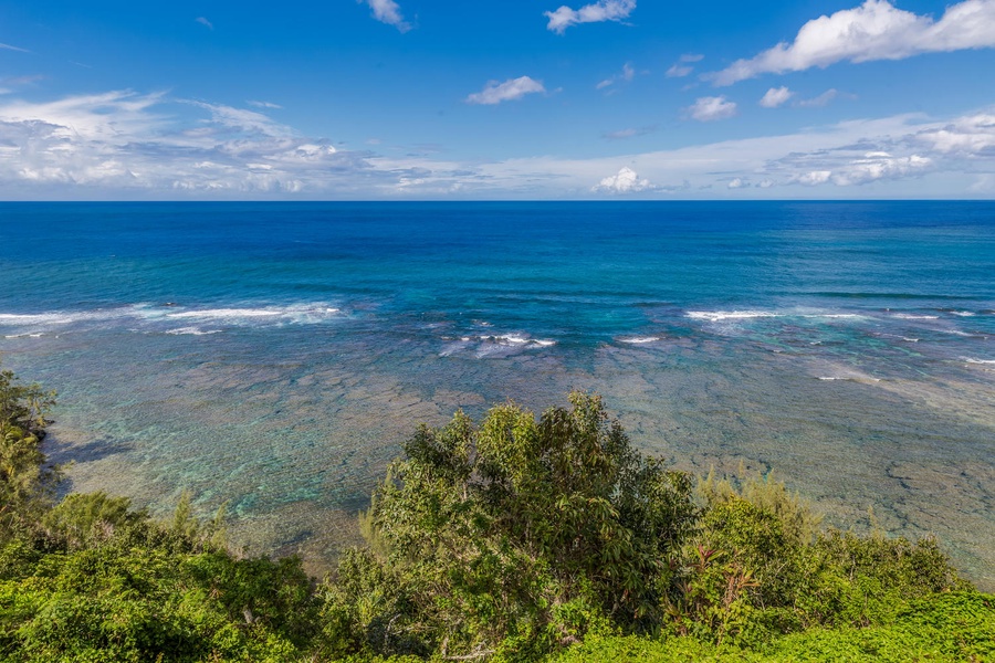 Sparkling waters and rugged coastline under a bright blue sky.