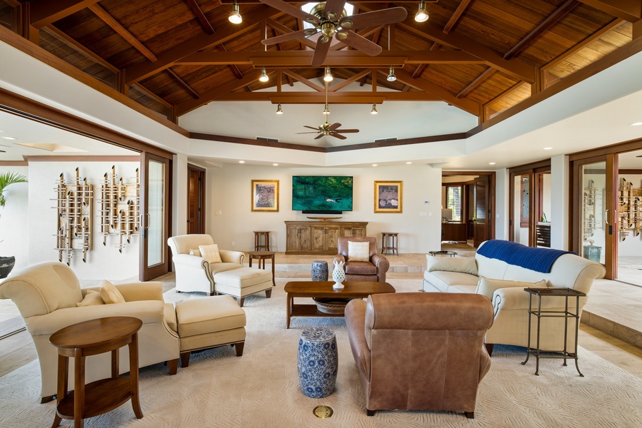 Gather in the elegant great room where wood-paneled ceilings and curated art offer both style and comfort.