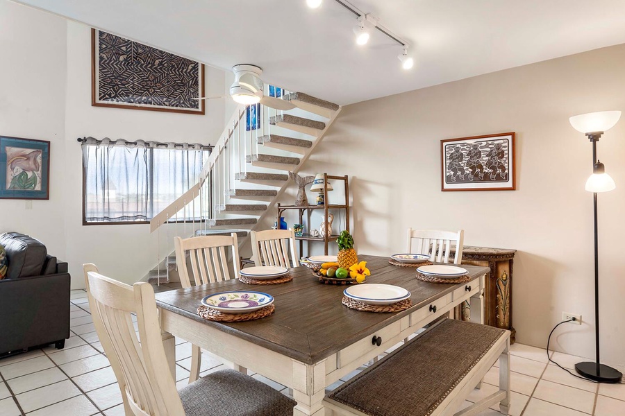 Dining area located right off the stairs with peeking lanai views.