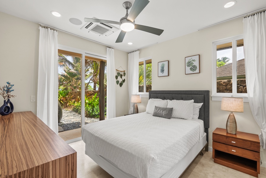 The lower-level bedroom with a queen bed and private lanai.